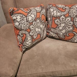 Two orange gray white paisley toss pillows